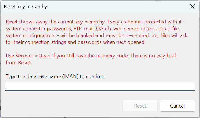 The Reset key hierarchy window. A warning says that Reset throws away the current key hierarchy, that every credential protected with it will be blanked and must be re-entered, that job files will ask for their connection strings and passwords when next opened, and to use Recover instead if you still have the recovery code. Below it, "Type the database name (IMAN) to confirm." with an empty box, and the Reset and Cancel buttons